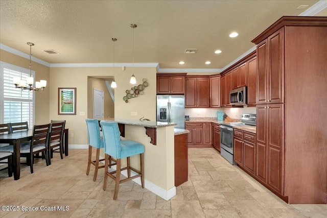 kitchen with hanging light fixtures, light stone countertops, a breakfast bar, ornamental molding, and stainless steel appliances