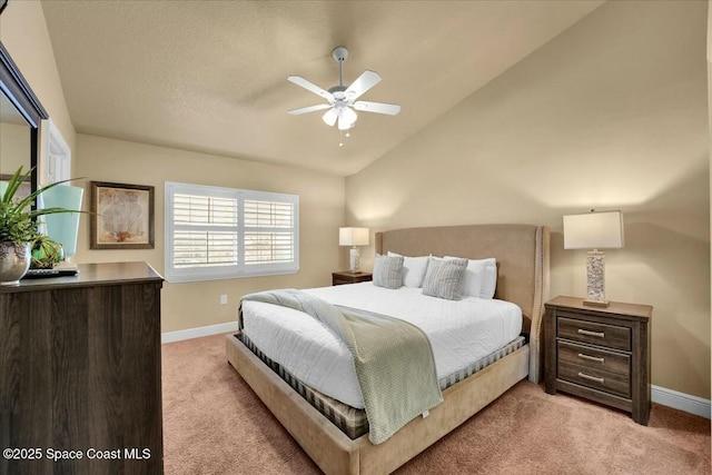 carpeted bedroom with vaulted ceiling and ceiling fan