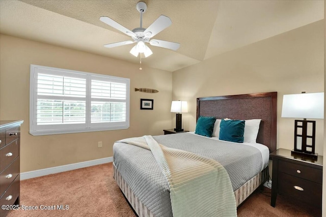 bedroom with ceiling fan, light colored carpet, and vaulted ceiling