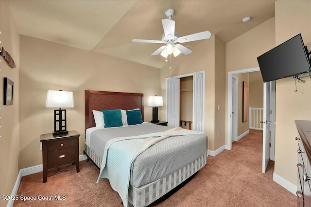 carpeted bedroom featuring ceiling fan, a closet, and lofted ceiling