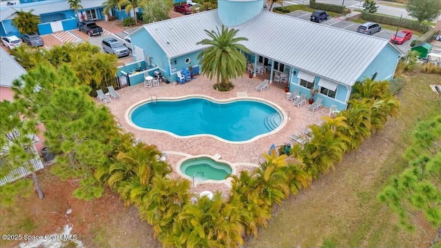 view of swimming pool featuring grilling area and a patio