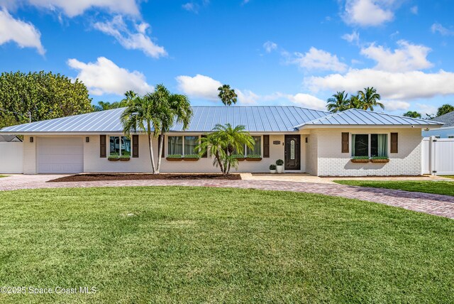 ranch-style home with a front lawn and a garage