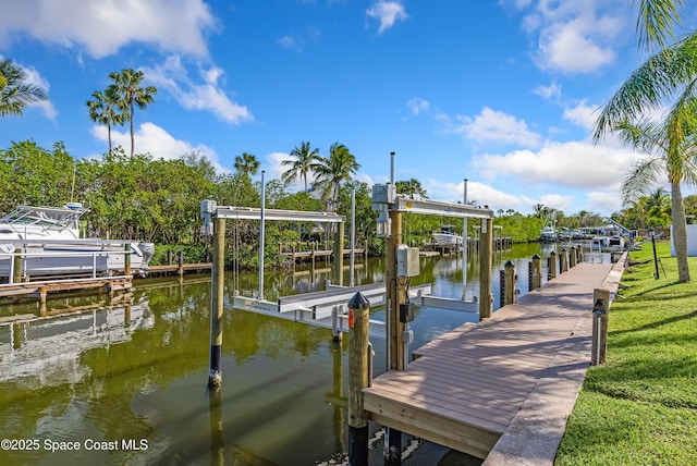 view of dock with a yard and a water view