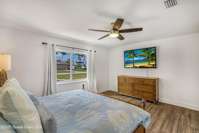 bedroom with ceiling fan and dark wood-type flooring