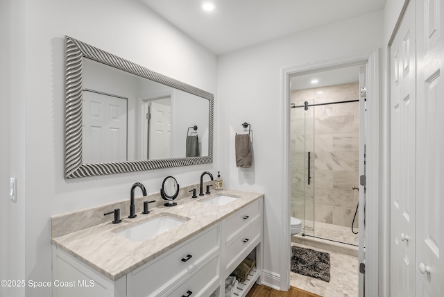 bathroom with toilet, vanity, and walk in shower