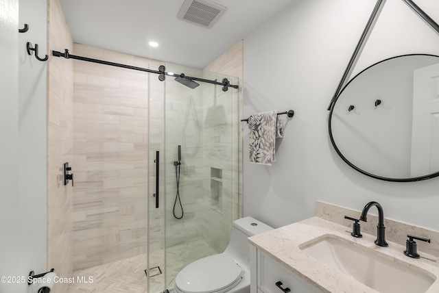 bathroom with vanity, toilet, and an enclosed shower