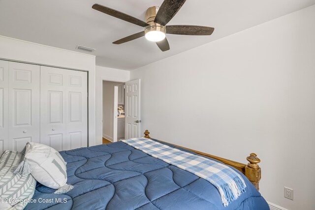 bedroom with ceiling fan and a closet