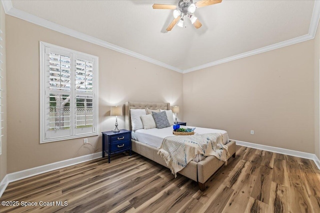 bedroom with ornamental molding, ceiling fan, and dark hardwood / wood-style floors