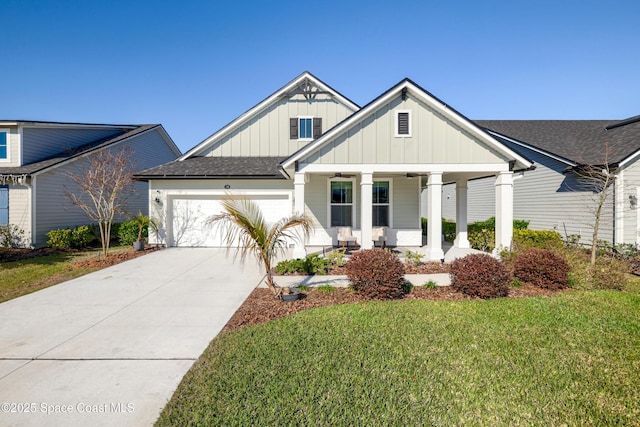 view of front of property with a garage, covered porch, and a front yard