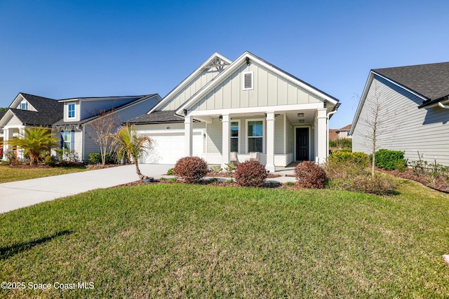 view of front of property with covered porch, a garage, and a front yard