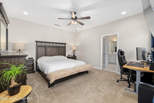 carpeted bedroom featuring ensuite bath and ceiling fan