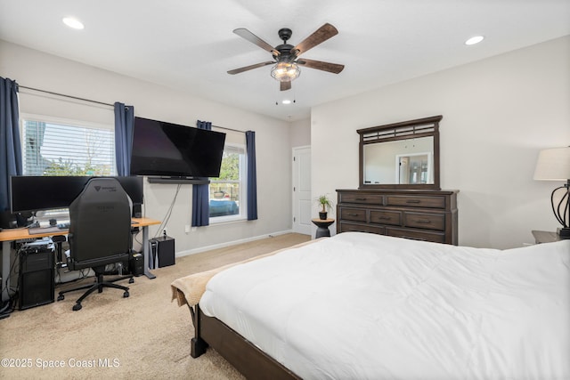 bedroom with ceiling fan and light colored carpet