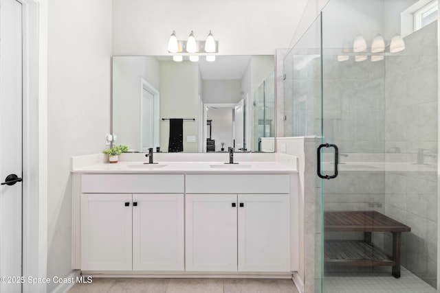 bathroom featuring tile patterned flooring, vanity, and a shower with door