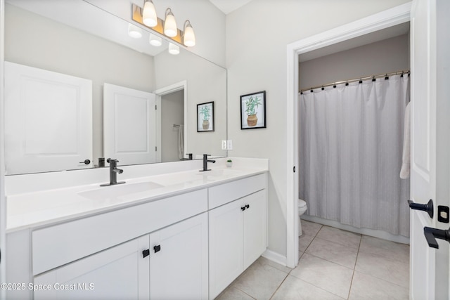 bathroom featuring toilet, vanity, tile patterned floors, and curtained shower