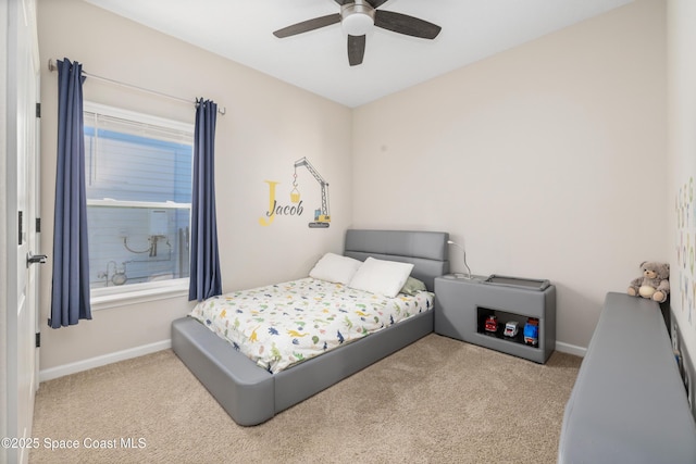 carpeted bedroom featuring multiple windows and ceiling fan