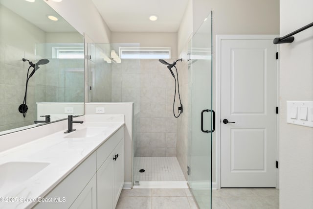 bathroom featuring tile patterned flooring, vanity, and a shower with shower door