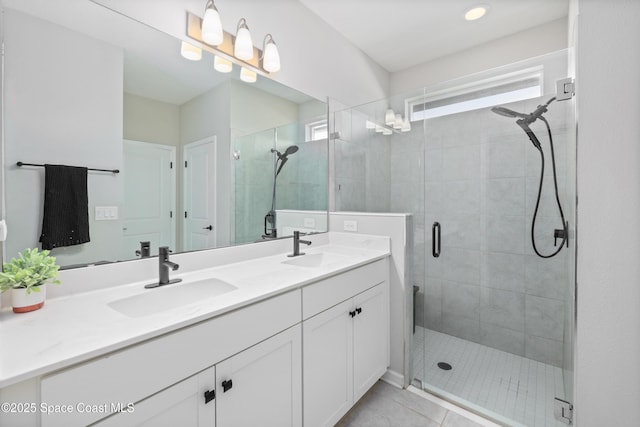 bathroom with tile patterned flooring, vanity, and an enclosed shower