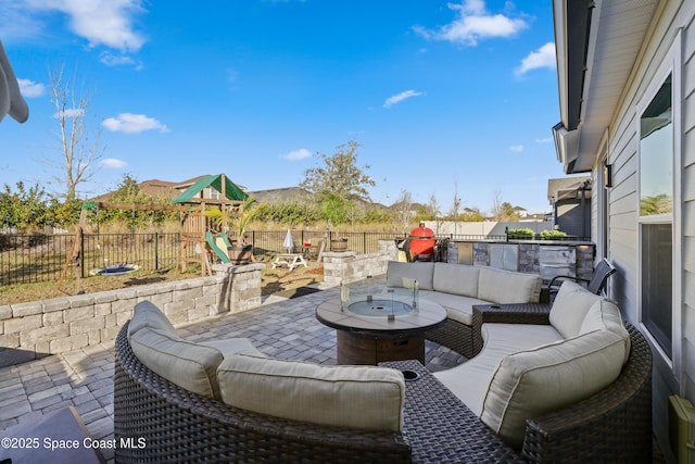 view of patio / terrace featuring an outdoor living space and a playground