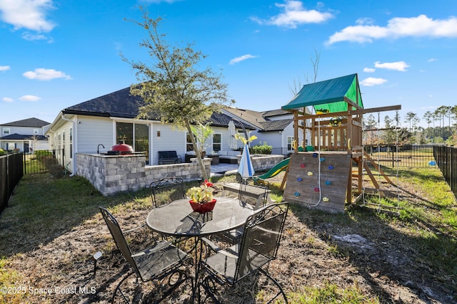 back of house featuring a playground