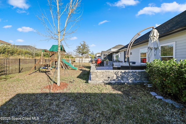 view of yard with an outdoor living space and a playground