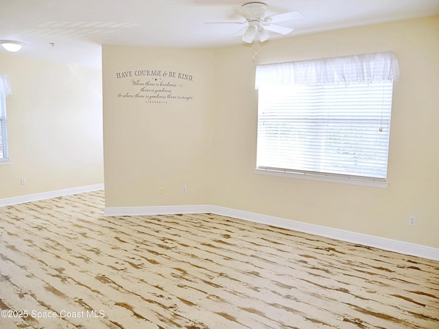 spare room with ceiling fan and light wood-type flooring