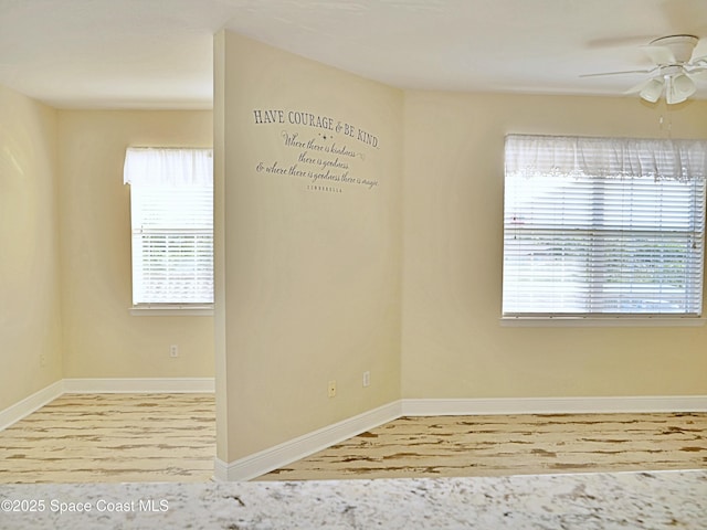 empty room featuring ceiling fan and hardwood / wood-style floors