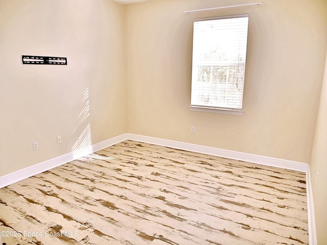 spare room with wood-type flooring