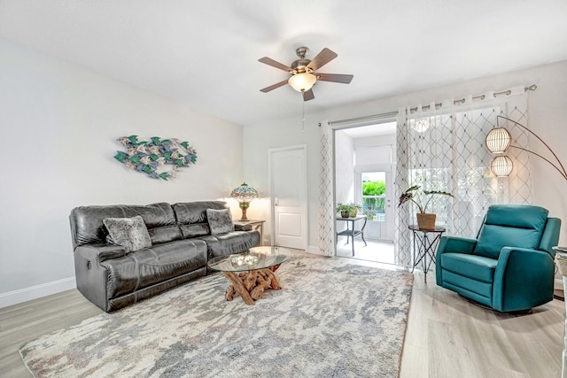 living room featuring light wood-type flooring and ceiling fan