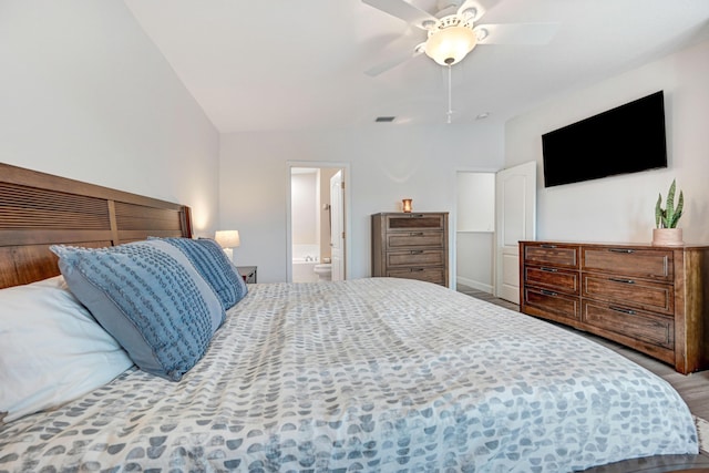 bedroom featuring ensuite bath, ceiling fan, and vaulted ceiling