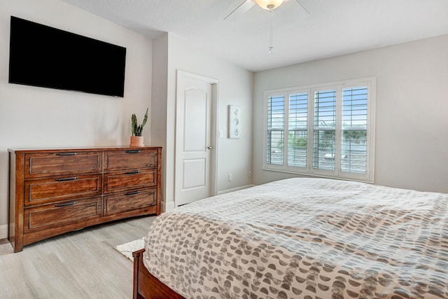 bedroom with ceiling fan and light wood-type flooring