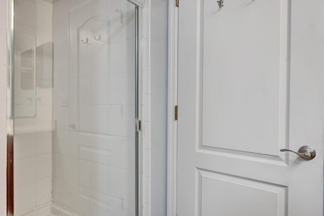 bathroom with a shower with shower door