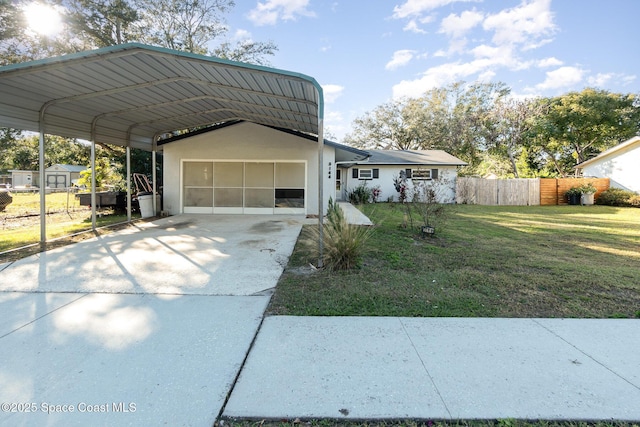 view of front facade with a front lawn and a carport