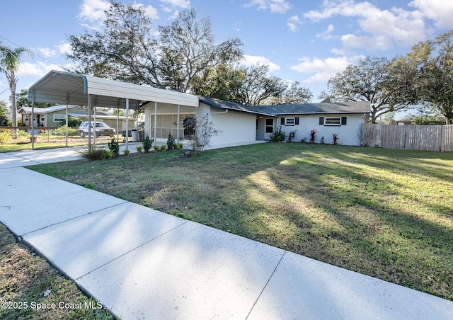 view of front facade with a carport and a front lawn