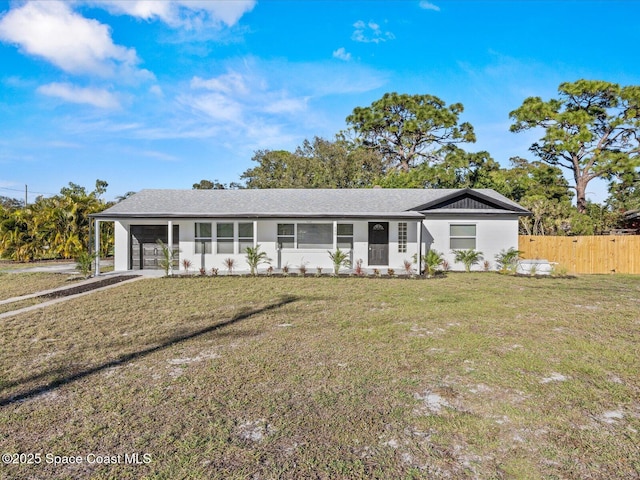 ranch-style house featuring a front lawn and a carport