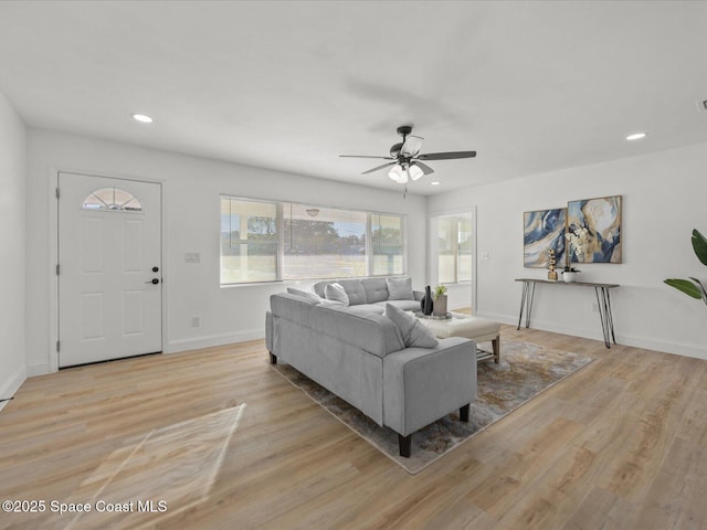 living room featuring light wood-type flooring and ceiling fan