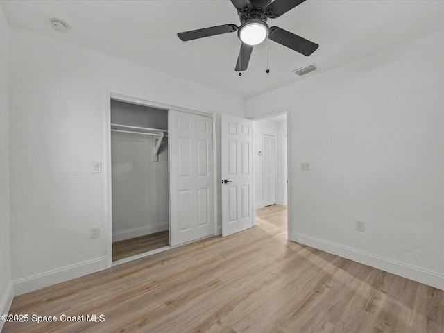 unfurnished bedroom with ceiling fan, light hardwood / wood-style flooring, and a closet