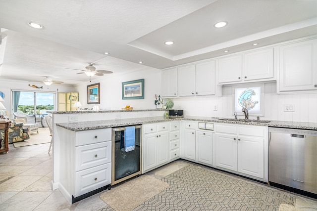 kitchen featuring dishwasher, kitchen peninsula, wine cooler, and sink