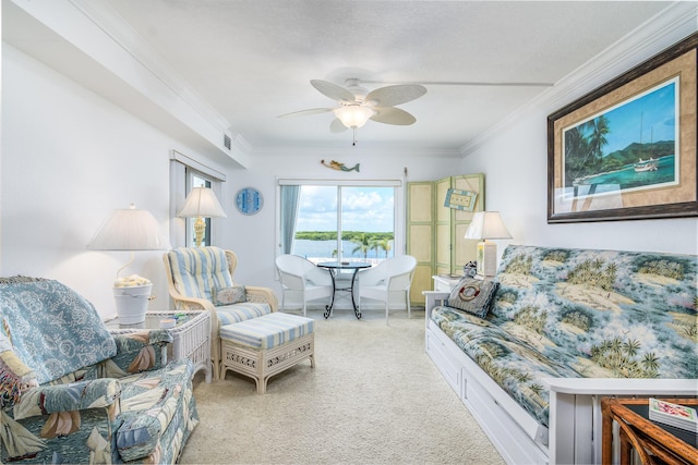 living room featuring a water view, ceiling fan, ornamental molding, and light colored carpet