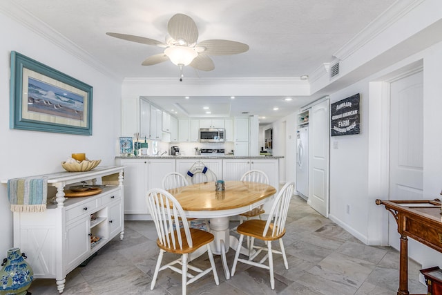 dining area with ceiling fan and ornamental molding