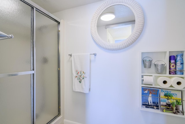 bathroom with a shower with door