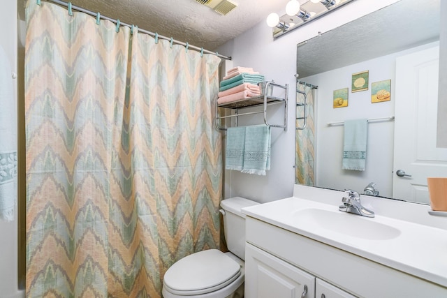 bathroom with a shower with shower curtain, vanity, toilet, and a textured ceiling