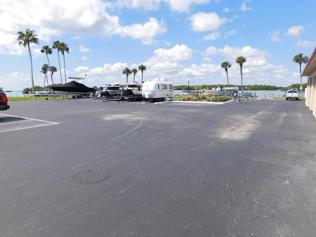 view of parking / parking lot featuring a water view