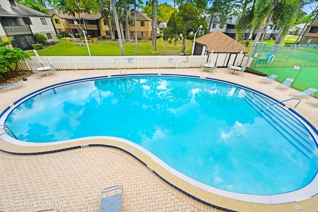 view of swimming pool with a patio