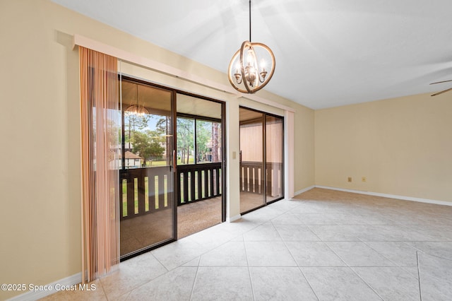 tiled empty room featuring a chandelier