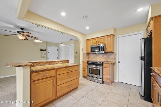 kitchen featuring pendant lighting, stainless steel appliances, tasteful backsplash, light tile patterned flooring, and ceiling fan