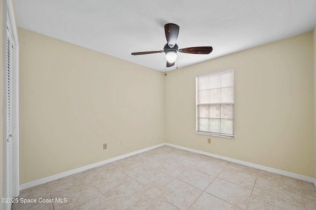 tiled empty room featuring ceiling fan