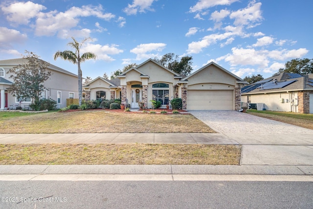 view of front of house with a front yard and a garage