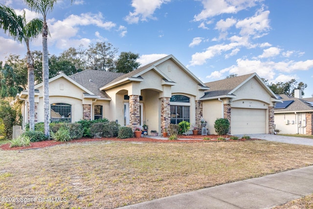 view of front of home featuring a garage and a front lawn