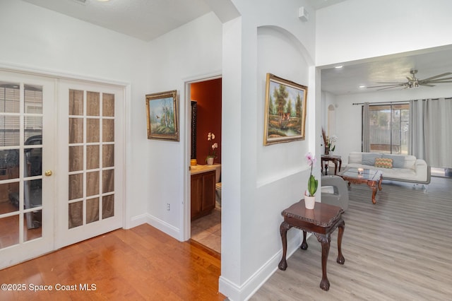 corridor featuring light hardwood / wood-style floors and french doors