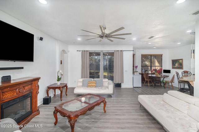 living room with ceiling fan and light hardwood / wood-style floors